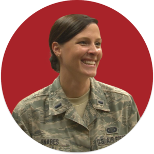 A white woman smiling in U.S. Air Force camo